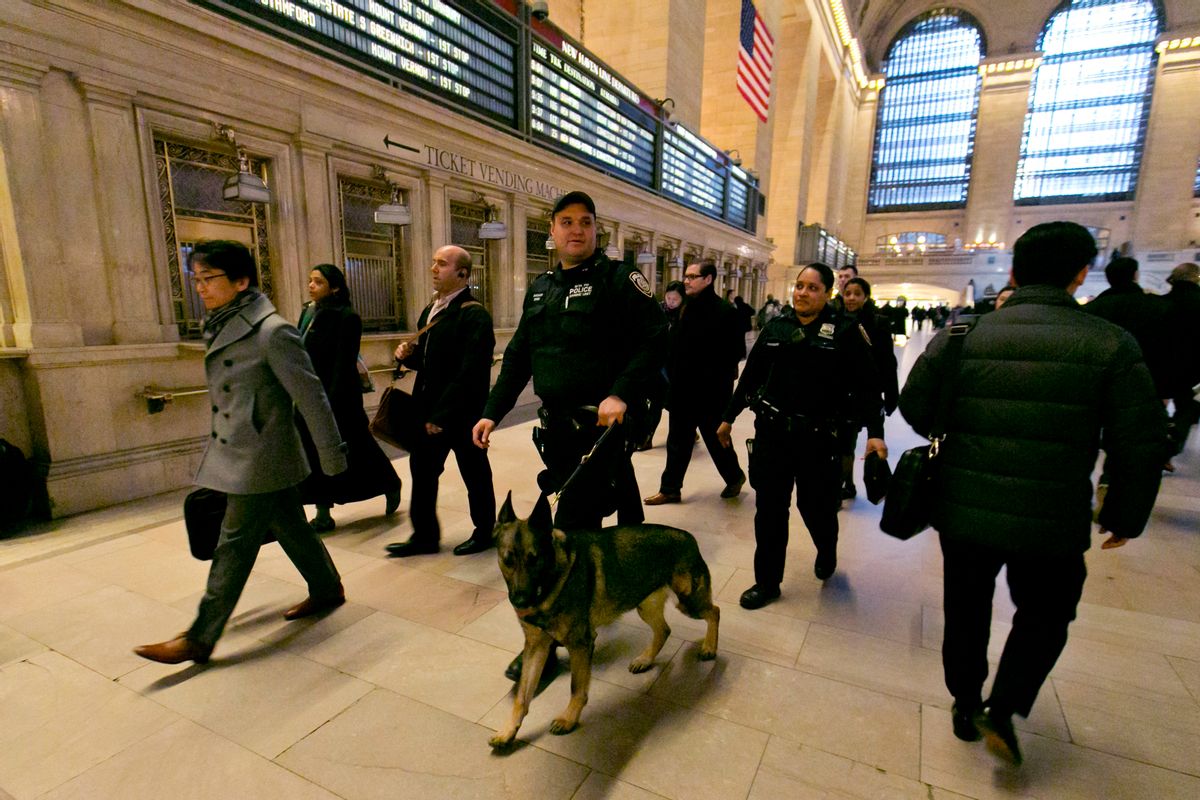 FILE - In this March 22, 2016 file photo, Metro-North Railroad police officers with a police dog patrol Grand Central Terminal, in New York.  The best line of defense against a Brussels-style attack in the nation's largest subway system may be man's best friend. The NYPD this week graduated eight new dogs specifically for its elite counterterrorism unit. (AP Photo/Richard Drew)