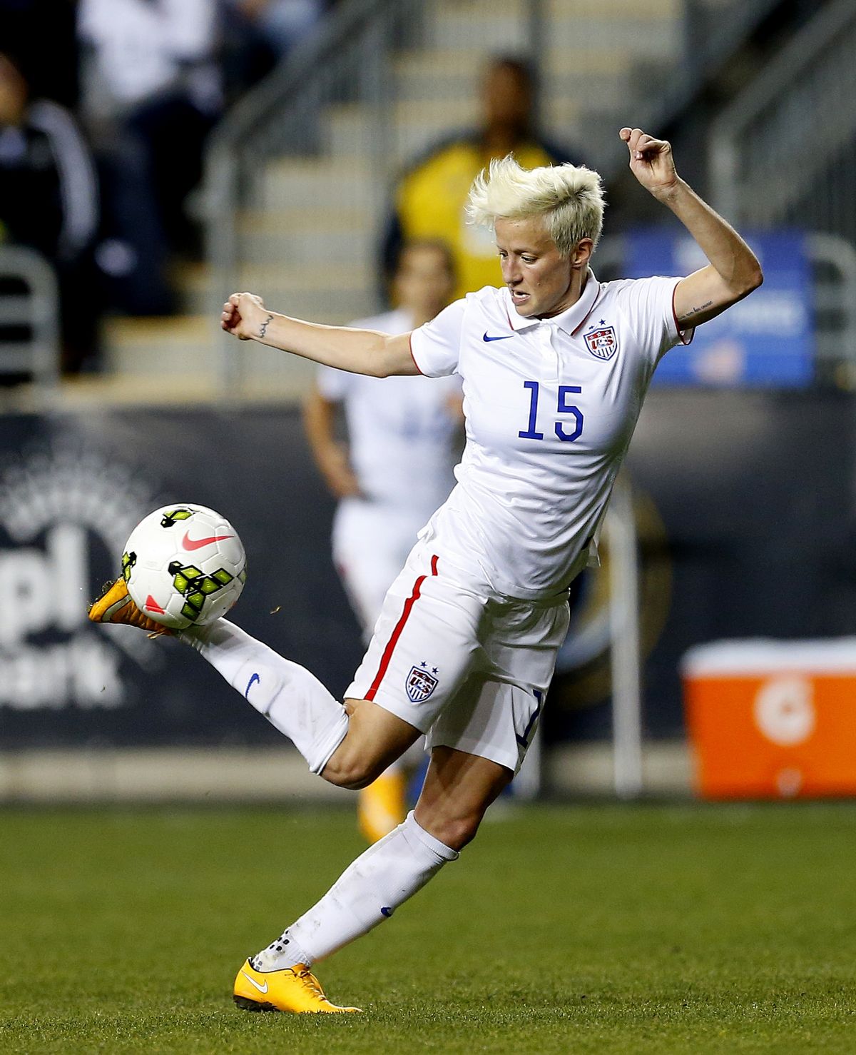 FILE - In this Oct. 24, 2014, file photo, United States midfielder Megan Rapinoe (15) against Mexico in the second half during a CONCACAF semifinal soccer match in Chester, Pa. Five players from the World Cup-winning U.S. national team have accused the U.S. Soccer Federation of wage discrimination in an action filed with the Equal Employment Opportunity Commission. Alex Morgan, Carli Lloyd, Megan Rapinoe, Becky Sauerbrunn and Hope Solo maintain in the EEOC filing they were payed nearly four times less than their male counterparts on the U.S. men's national team. The filing was announced in a press release on Thursday, March 31, 2016. (AP Photo/Rich Schultz, File) (AP)