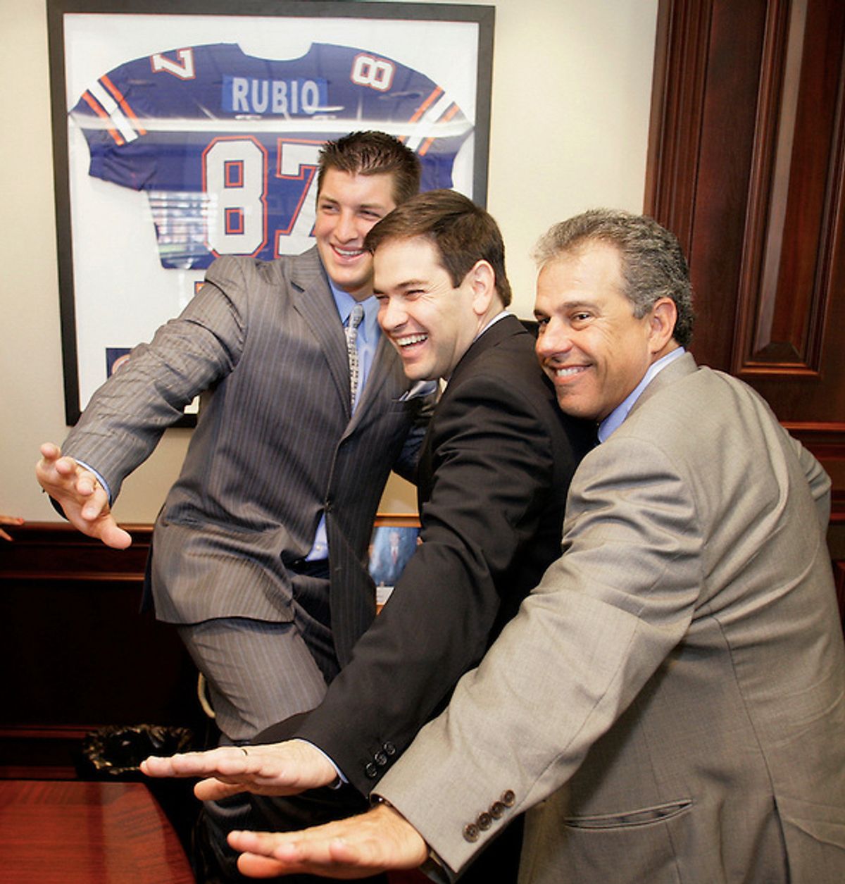 University of Florida quarterback and 2007 Heisman Trophy winner Tim Tebow (L), Speaker of the Florida House of Represenatives Marco Rubio, (C) and University of Florida board of trustee member Carlos Alfonso strike a Heisman pose in Rubio's office at the Florida State Capitol April 24, 2008.  (Mark Wallheiser/TallahasseeStock.com)