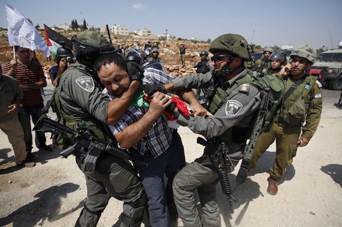 Israeli forces detain a Palestinian protester during a demonstration against illegal Israeli settlements in the occupied West Bank village of Nabi Saleh, near Ramallah on September 4, 2015  (Reuters/Mohamad Torokman)