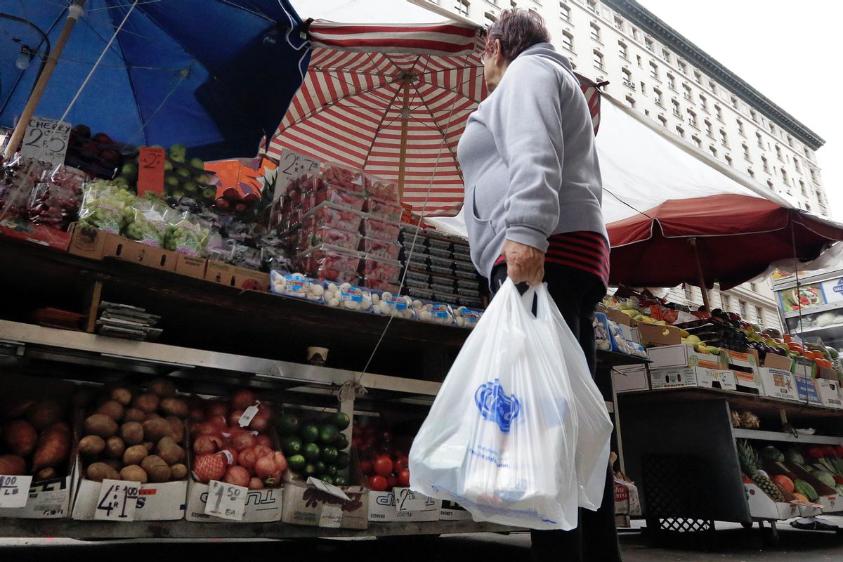 A woman carrying her supermarket purchase in plastic bags stops at a produce vendor on New York's Upper West Side, Thursday, May 5, 2016.  (AP Photo/Richard Drew) (AP)