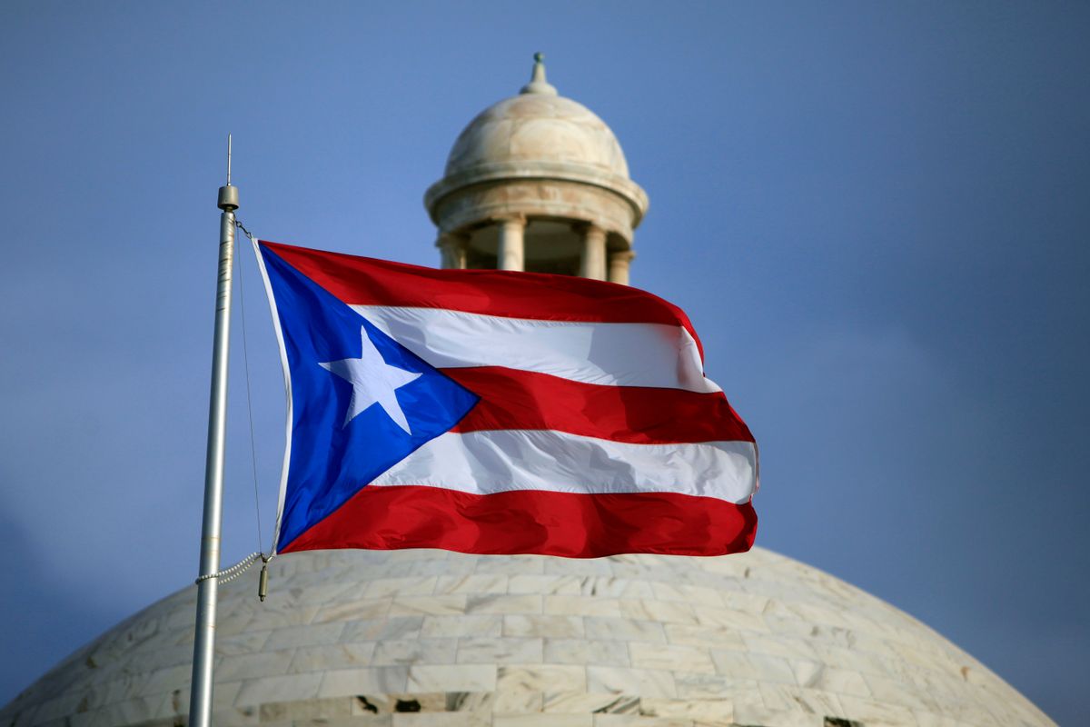 FILE - In this Wednesday, July 29, file 2015 photo, the Puerto Rican flag flies in front of Puerto Ricos Capitol as in San Juan, Puerto Rico. Puerto Rico Gov. Alejandro Javier Garcia Padilla said on Sunday, May 1, 2016, that negotiators for the U.S. territorys government have failed to reach a last-minute deal to avoid a third default and that he has issued an executive order to withhold payment.  (AP Photo/Ricardo Arduengo, File)