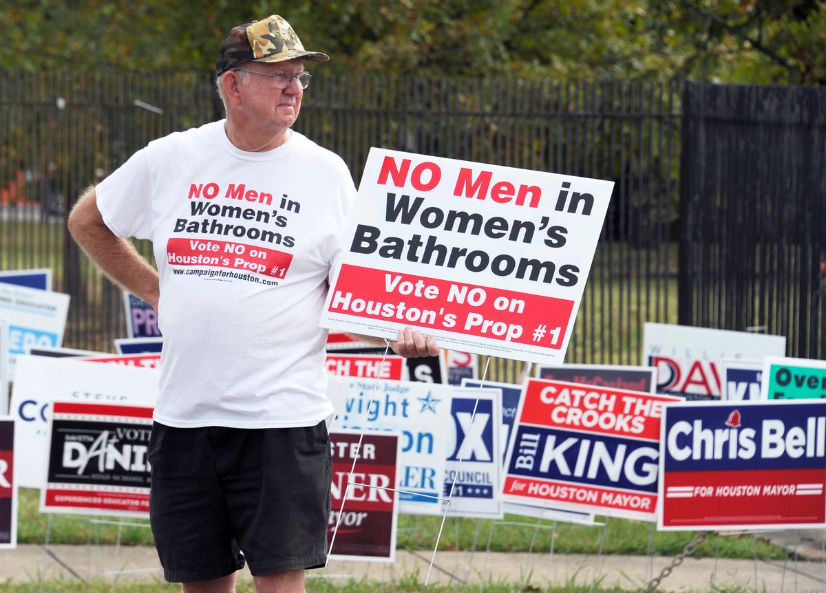 FILE - In this Wednesday, Oct. 21, 2015 file photo, a demonstrator holds a sign against the Houston Equal Rights Ordinance outside an early voting center in Houston. The contested ordinance is a broad measure that would consolidate existing bans on discrimination tied to race, sex, religion and other categories in employment, housing and public accommodations, and extend such protections to gays, lesbians, bisexuals and transgender people. The anti-bias ordinance was repealed in a November 2015 referendum. () (AP Photo/Pat Sullivan)