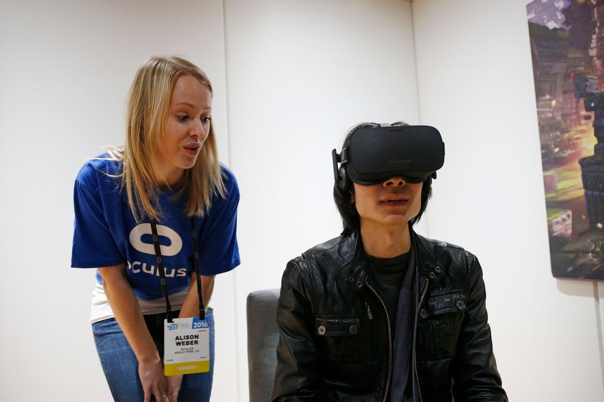 FILE - In this Jan. 6, 2016 file photo, Alison Weber, left, instructs Peijun Guo on using the Oculus Rift VR headset at the Oculus booth at CES International in Las Vegas. After delaying orders because of component shortages and angering wannabe early adopters, VR company Oculus is confronting another headache as it seeks to technologically and culturally establish the immersive medium. It's now possible to play titles that were intended to only be used with the Oculus Rift system on an entirely different VR headset. (AP Photo/John Locher, File) (AP)