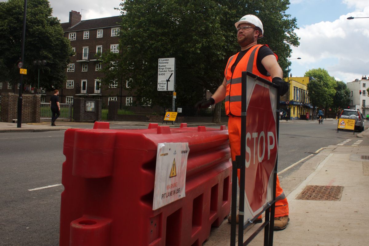 In this photo taken on Friday, June 24, 2016, Gabriel Ionut, a 24-year-old Romanian who works as a traffic marshal, stands by a signal at a construction site in London. (AP Photo, Pawel Kuczynski)