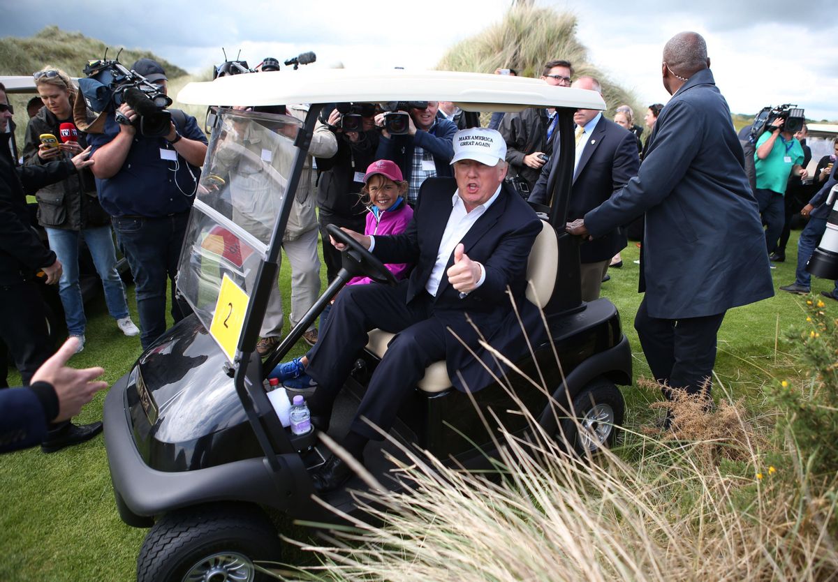 US presidential candidate Donald Trump chats with the watching media aboard a golf cart with granddaughter Kai after he arrived at the Trump International Golf Links at Balmedie, near Aberdeen, Scotland, Saturday June 25, 2016.  Presidential hopeful Donald Trump is on a short break away from his presidential campaign. (Andrew Milligan / PA via AP) UNITED KINGDOM OUT - NO SALES - NO ARCHIVES (AP)