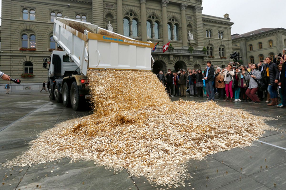 A truck dumps coins onto Federal Square in Bern, Switzerland, during a an event organized by the Committee for the initiative "CHF 2,500 monthly for everyone," October 4, 2013.   (Reuters/Denis Balibouse)