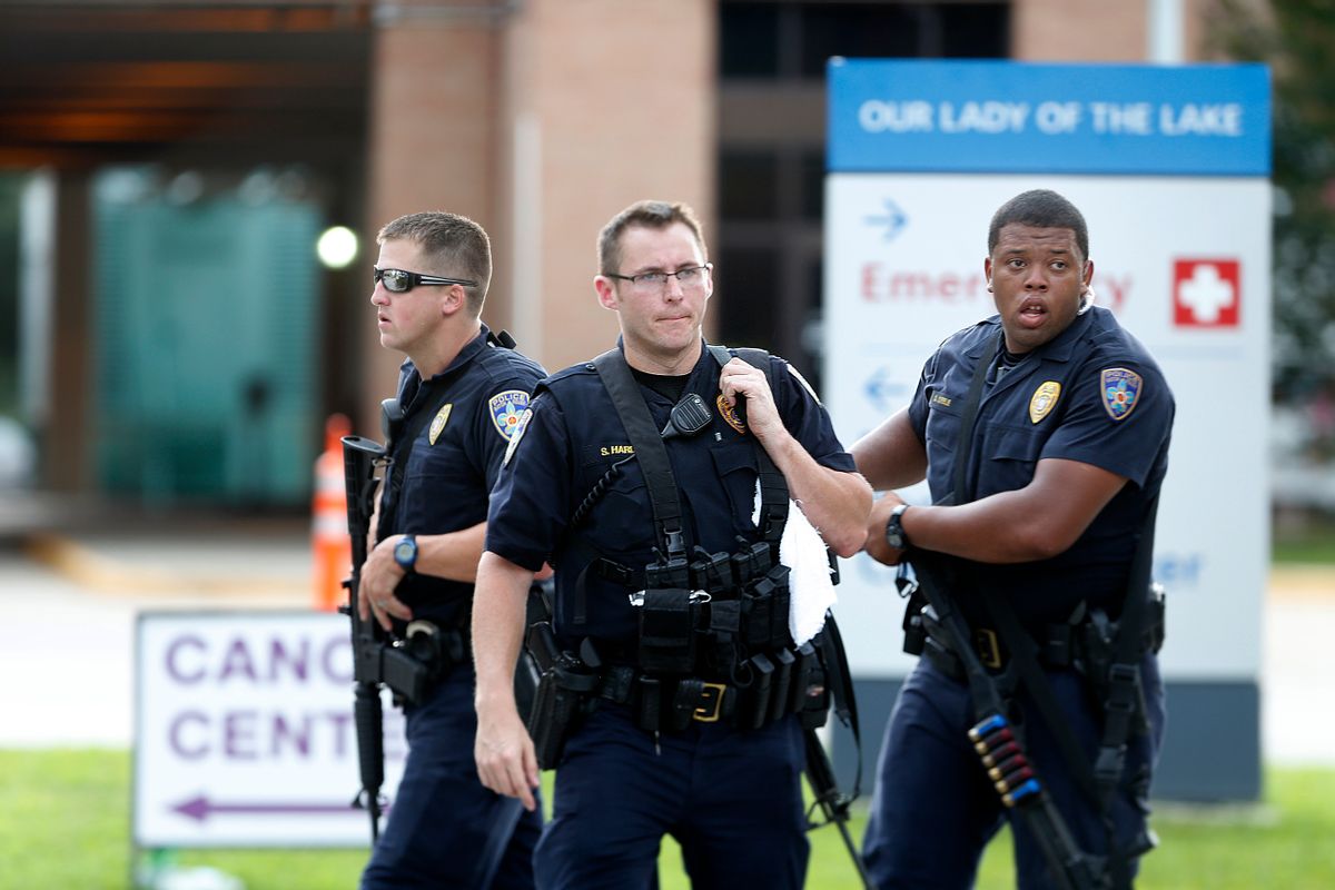 Police guard the emergency room entrance of Our Lady Of The Lake Medical Center, where wounded officers were brought, in Baton Rouge, La., Sunday, July 17, 2016. Multiple law enforcement officers were killed and wounded Sunday morning in a shooting near a gas station in Baton Rouge, less than two weeks after a black man was shot and killed by police here, sparking nightly protests across the city. (AP Photo/Gerald Herbert) (AP)