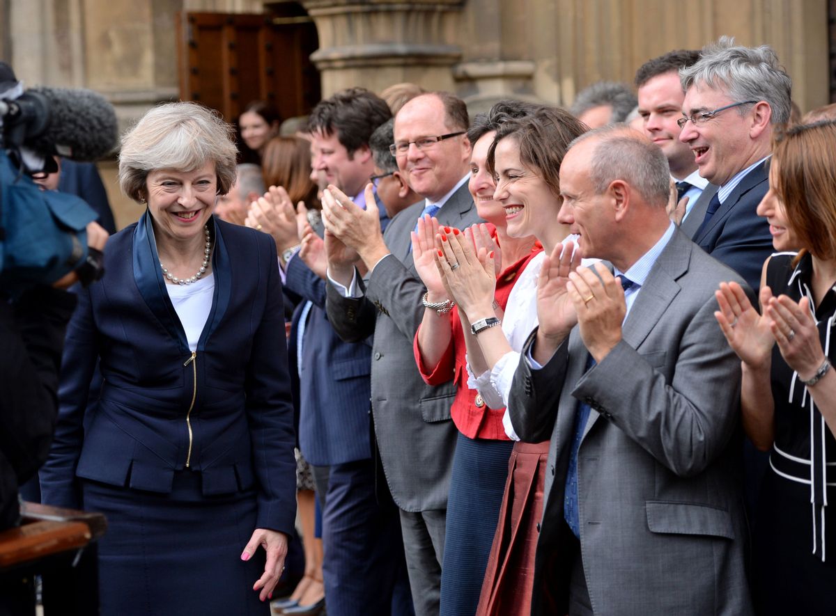 Britain's Theresa May, left, is applauded by Conservative Party members of parliament outside the Houses of Parliament in London, Monday July 11, 2016. Britain's Conservative Party has confirmed that Theresa May has been elected party leader "with immediate effect" and will become the country's next prime minister. Prime Minister David Cameron has said he will step down on Wednesday July 13, 2016 and May will immediately replace him. (Dominic Lipinski/PA via AP) (AP)