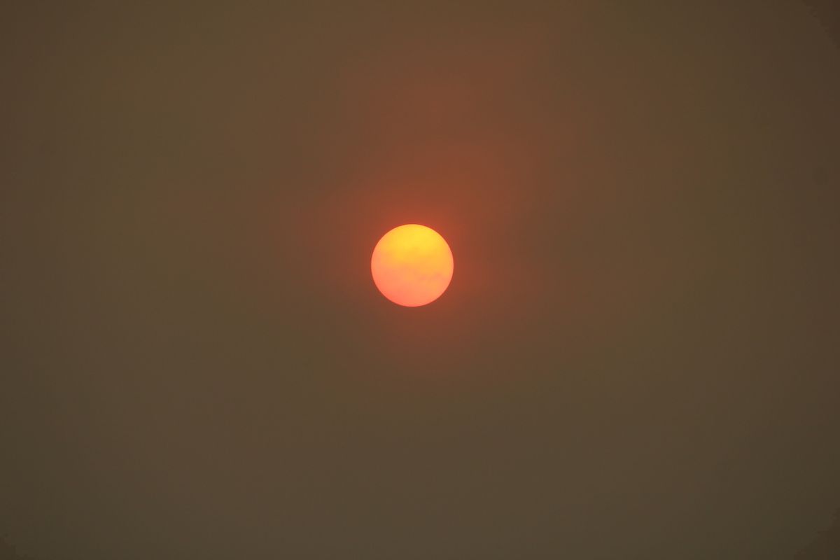 The morning sun over Pasadena, Calif., is reduced to an orange disk by smoke from a wildfire burning north of Los Angeles on Saturday, July 23, 2016. The fire erupted Friday afternoon amid a withering heat wave and spread over thousands of acres while sending up a plume of smoke that spread widely and dropped ash across the region. (AP Photo/John Antczak) (AP)