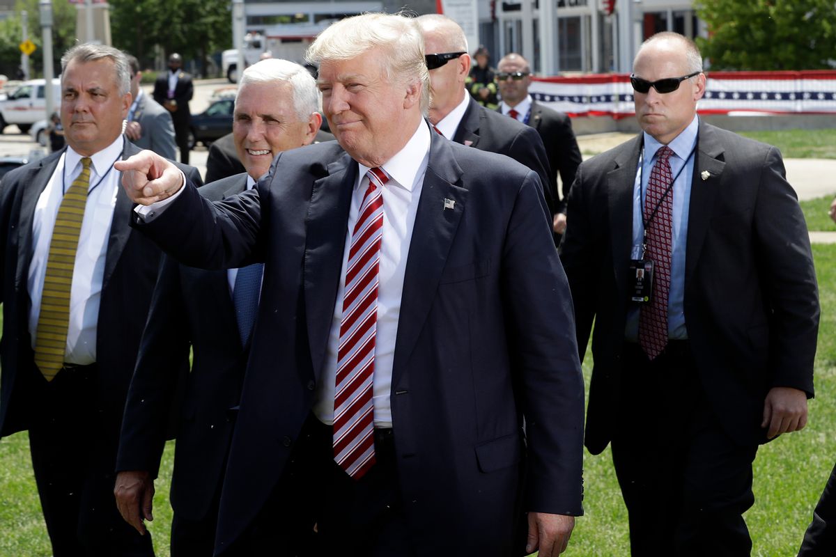 Republican presidential candidate Donald Trump, right, and Republican vice presidential candidate Gov. Mike Pence, R-Ind., walk toward supporters after Trump arrived via helicopter in Cleveland, Wednesday, July 20, 2016. (AP Photo/Mary Altaffer) (AP)