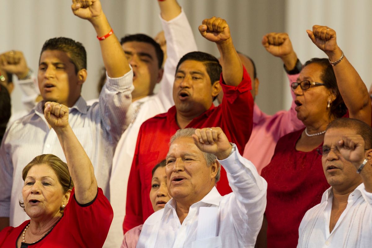 FILE - In this June 1, 2014 file photo, El Salvador's President Salvador Sanchez Ceren sings the Farabundo Marti National Liberation Front anthem during a rally with party supporters after his swearing-in ceremony in San Salvador, El Salvador. Sanchez Ceren says he has begun talks with political parties on a new "national reconciliation" law after the Supreme Court overturned an amnesty covering crimes committed during the 1980-1992 civil war. (AP Photo/Moises Castillo, File) (AP)
