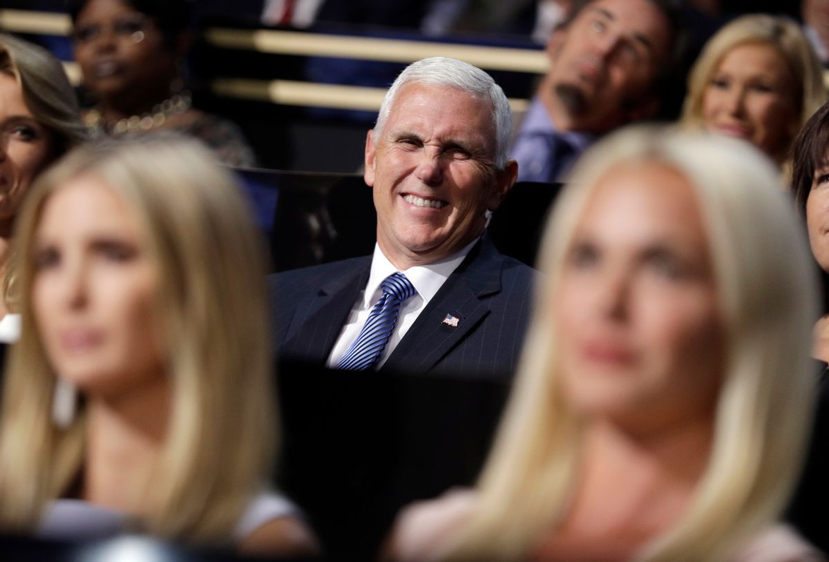 Vice Presidential nominee Gov. Mike Pence of Indiana smiles as he sits during the second day session of the Republican National Convention in Cleveland,  (AP)