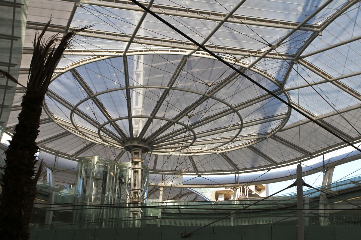 In this July 4, 2016 photo, the sun sets through the rooftop glass above one of the new Abdali Mall's light tubes, which redirects sunlight from the roof to the basement of Jordan's first energy-efficient shopping complex in Amman, Jordan. High-end boutiques, cinemas and gourmet coffee shops are tucked into an intricate ecosystem of natural heating and cooling, water recycling and hundreds of solar panels soaking up the sun's rays. Advocates for green building say sustainable building development is important in Jordan, where energy and water resources are quickly diminishing. (Layla Quran/AP Photo) (AP)