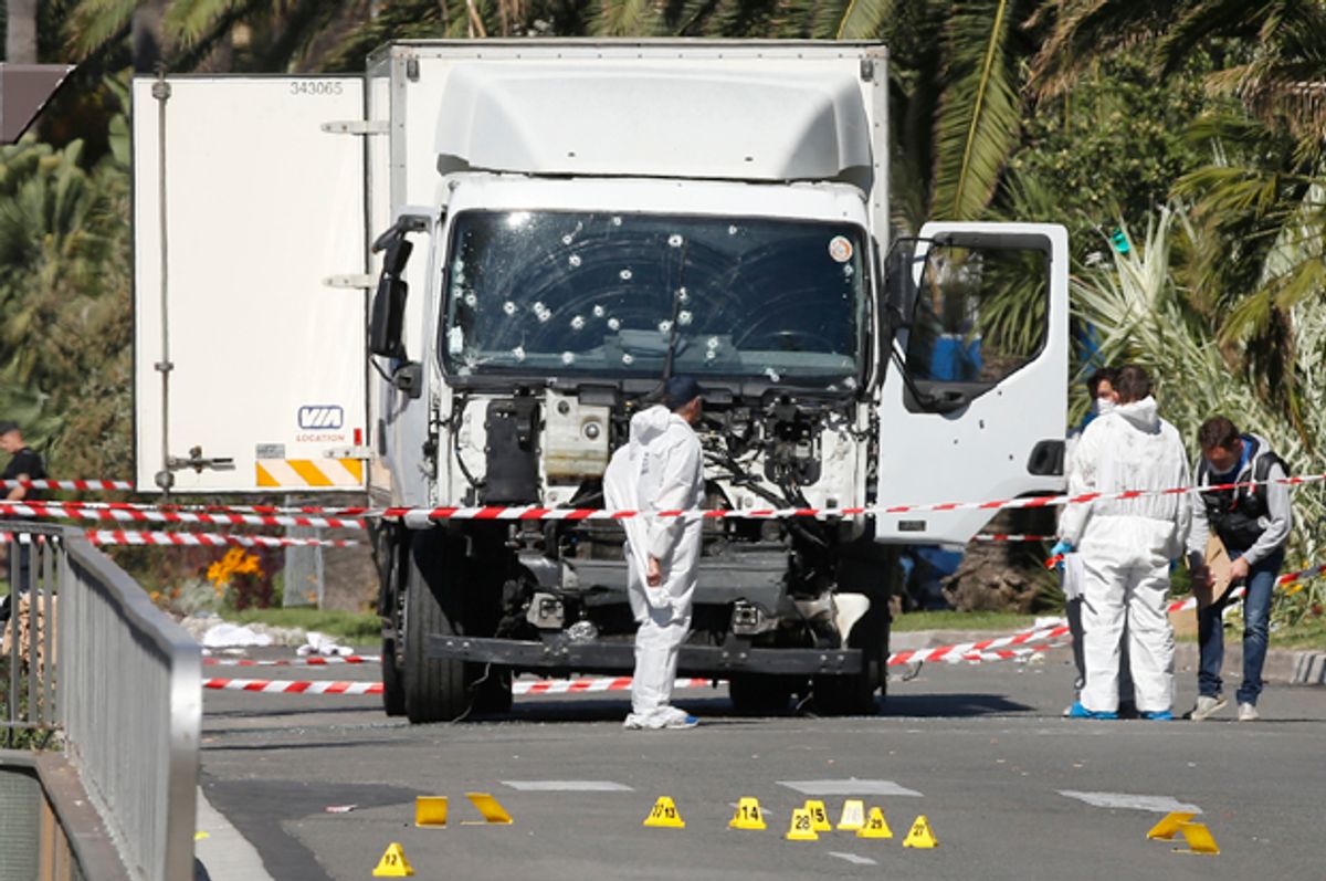 Investigators work at the scene near the heavy truck that ran into a crowd in Nice, France, July 15, 2016.    (Reuters/Eric Gaillard)