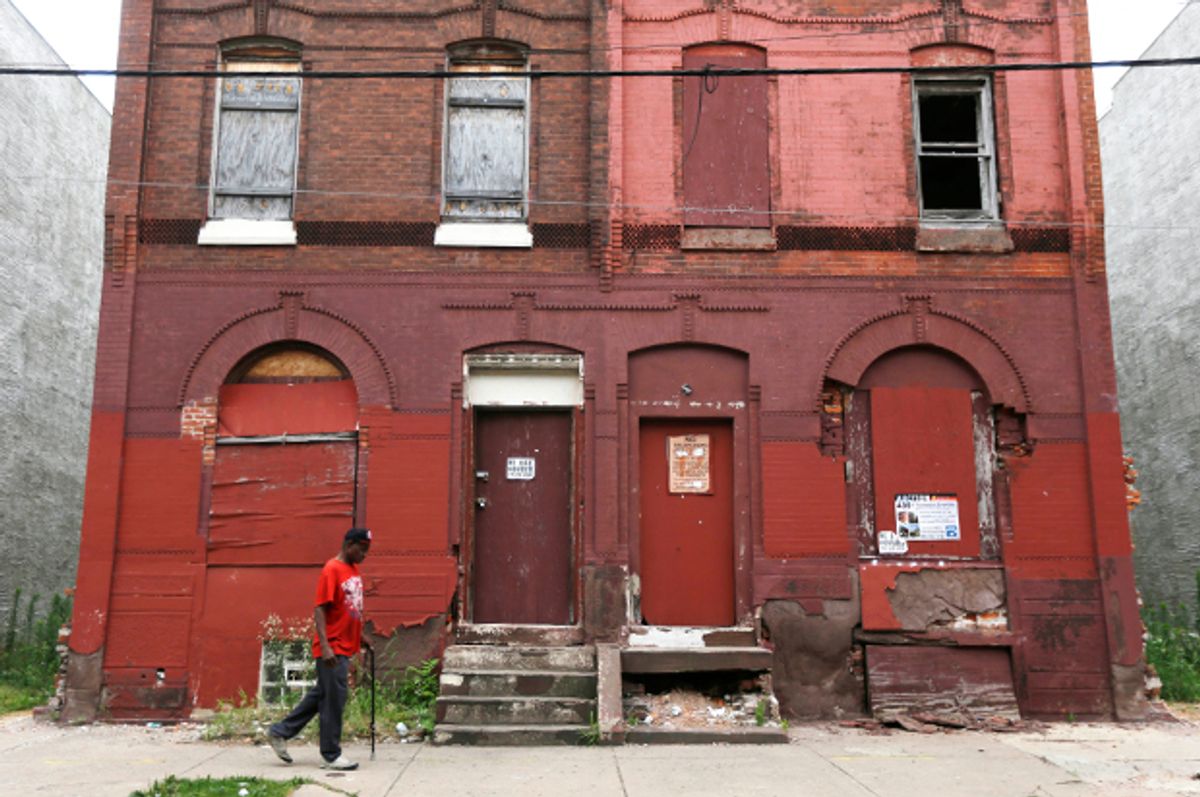 A man walks through a blighted neighborhood, July 11, 2013, in Philadelphia.   (AP/Matt Rourke)