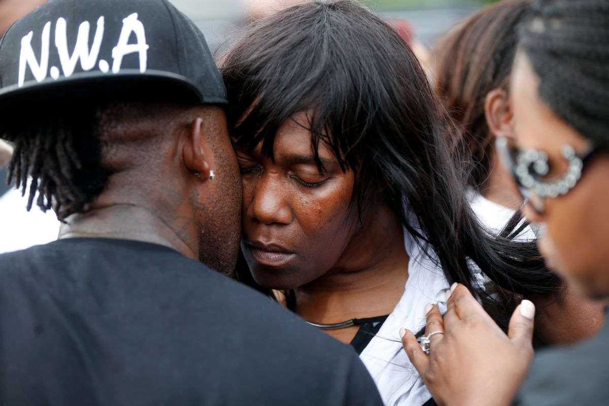 Sandra Sterling, aunt of Alton Sterling, is comforted at a vigil outside the Triple S convenience store in Baton Rouge, La., Wednesday, July 6, 2016. Sterling, 37, was shot and killed outside the store by Baton Rouge police, where he was selling CDs. (AP Photo/Gerald Herbert) (AP)