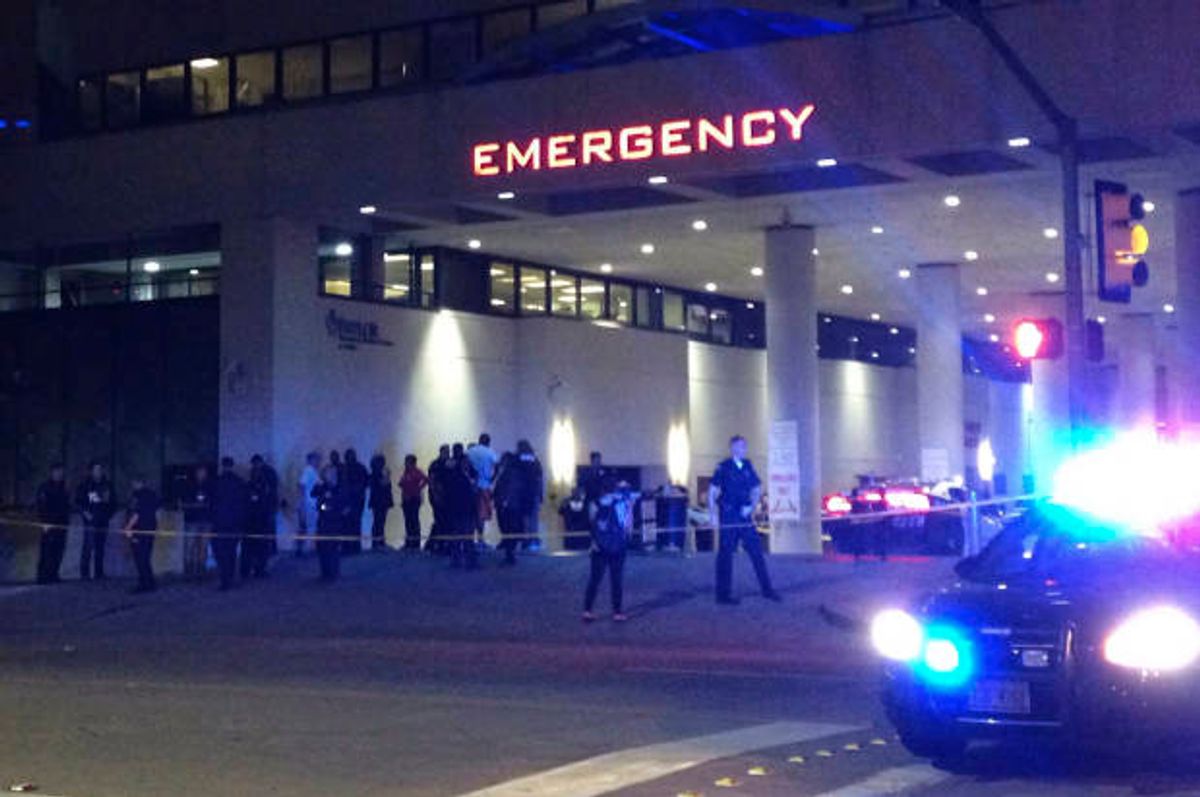 Police and others gather at the emergency entrance to Baylor Medical Center in Dallas, where several police officers were taken after shootings Thursday, July 7, 2016  (AP/Emily Schmall)