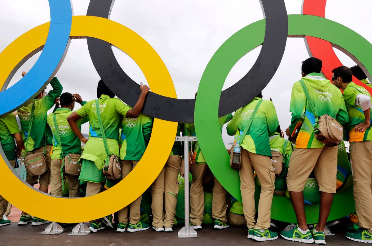 Volunteers pose for a photograph with a set of Olympic Rings inside Olympic Park in Rio de Janeiro, Brazil, Friday, July 29, 2016. (AP Photo/Patrick Semansky) (AP)