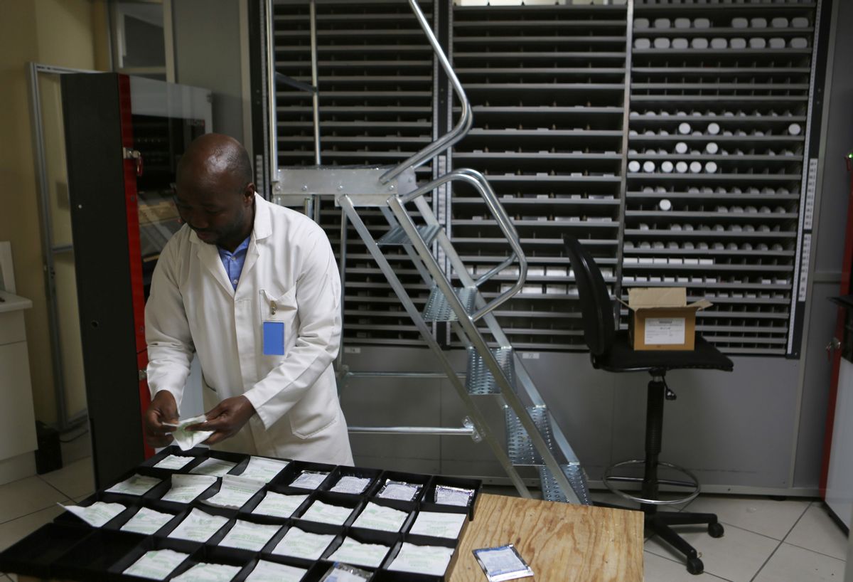 In this photo taken Friday July 15, 2016, a pharmacist makes up packets of drugs at the Helen Joseph Hospital in Johannesburg. In the largely black Johannesburg community of Alexandra, one project is trying to make drug delivery as convenient as withdrawing cash. What looks like a row of ATM machines has been installed in a shopping center, ready for an official rollout later this year. People will be able to walk up, insert their medical registration or speak via a video monitor with a pharmacy worker, select their prescription and pick up the drugs that pop out. (AP Photo/Denis Farrell) (AP)