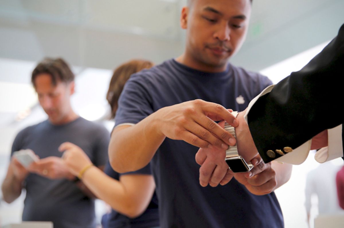 An Apple employee assists a customer with a new Apple Watch in San Francisco, June 17, 2015.   (Reuters/Robert Galbraith)