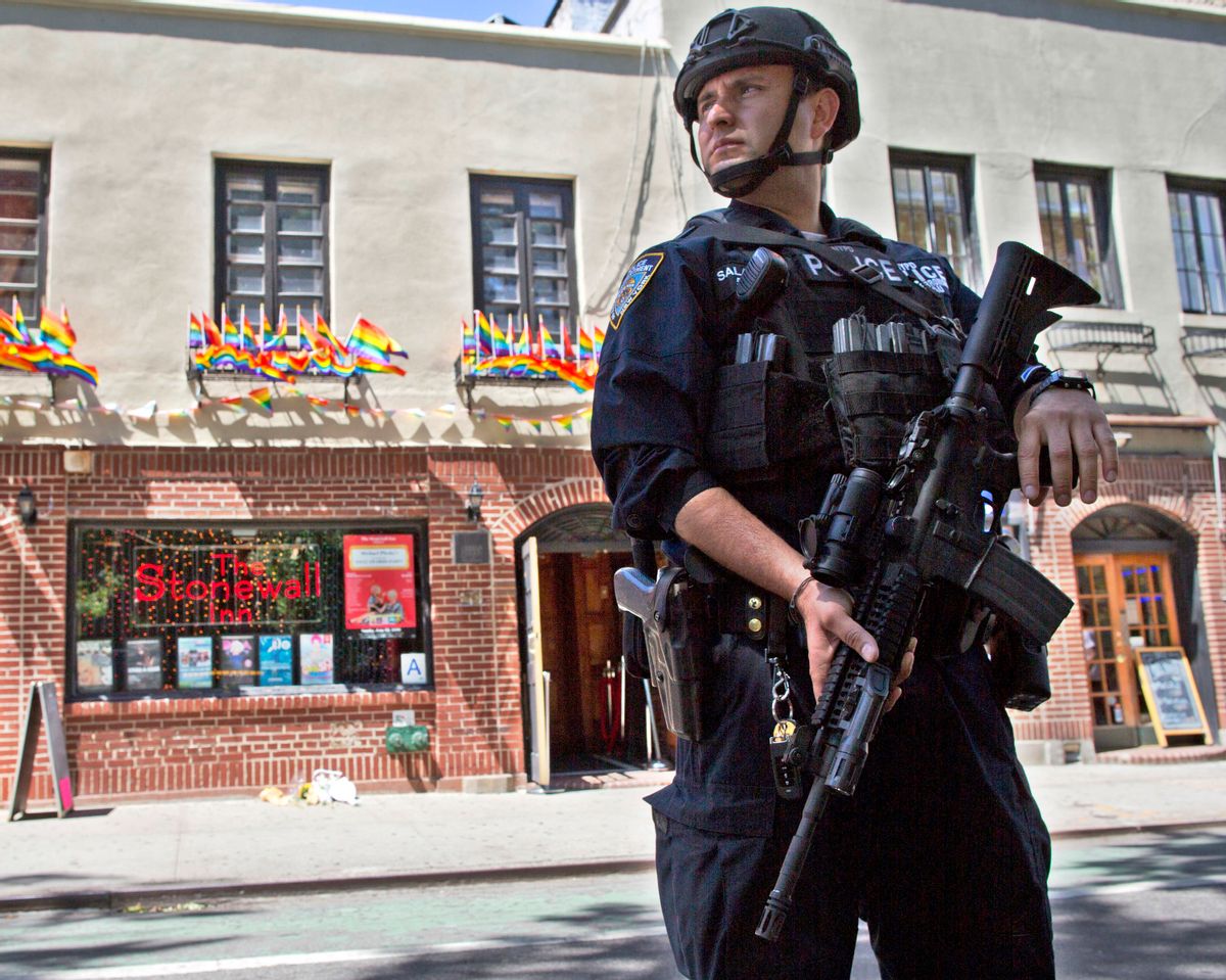 FILE - In this June 12, 2016 file photo, an armed police officer stands guard outside the Stonewall Inn, in New York after a Florida gunman's attack at a gay nightclub spread fear of more attacks. The officer is heavily armed and equipped, in a manner typical of the NYPD's counterterrorism unit and Emergency Service Unit - the NYPD's equivalent of SWAT officers. But the NYPD plans to distribute 20,000 helmets and 6,000 vests before the end of the year to uniformed patrol officers to protect them better during combat with rampaging shooters (AP Photo/Mary Altaffer, File) (AP)