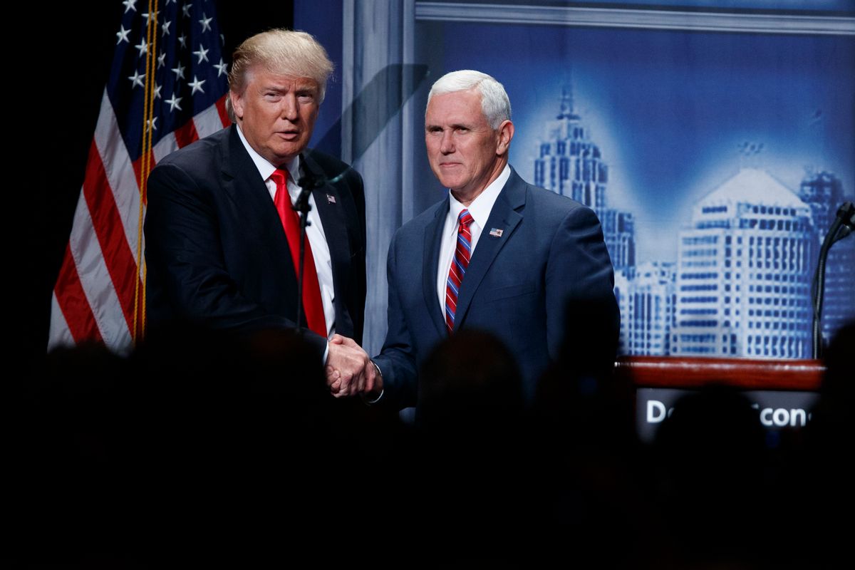 FILE- In this Aug. 8, 2016, file photo, Republican presidential candidate Donald Trump shakes hands with his running mate, Republican vice presidential candidate, Indiana Gov. Mike Pence as he arrives to give an economic policy speech to the Detroit Economic Club in Detroit. A campaign official familiar with the plans said Thursday, Aug. 18, that the GOP nominee and his running mate will tour the flood damage in ravaged Louisiana on Friday. (AP Photo/Evan Vucci, File) (AP)