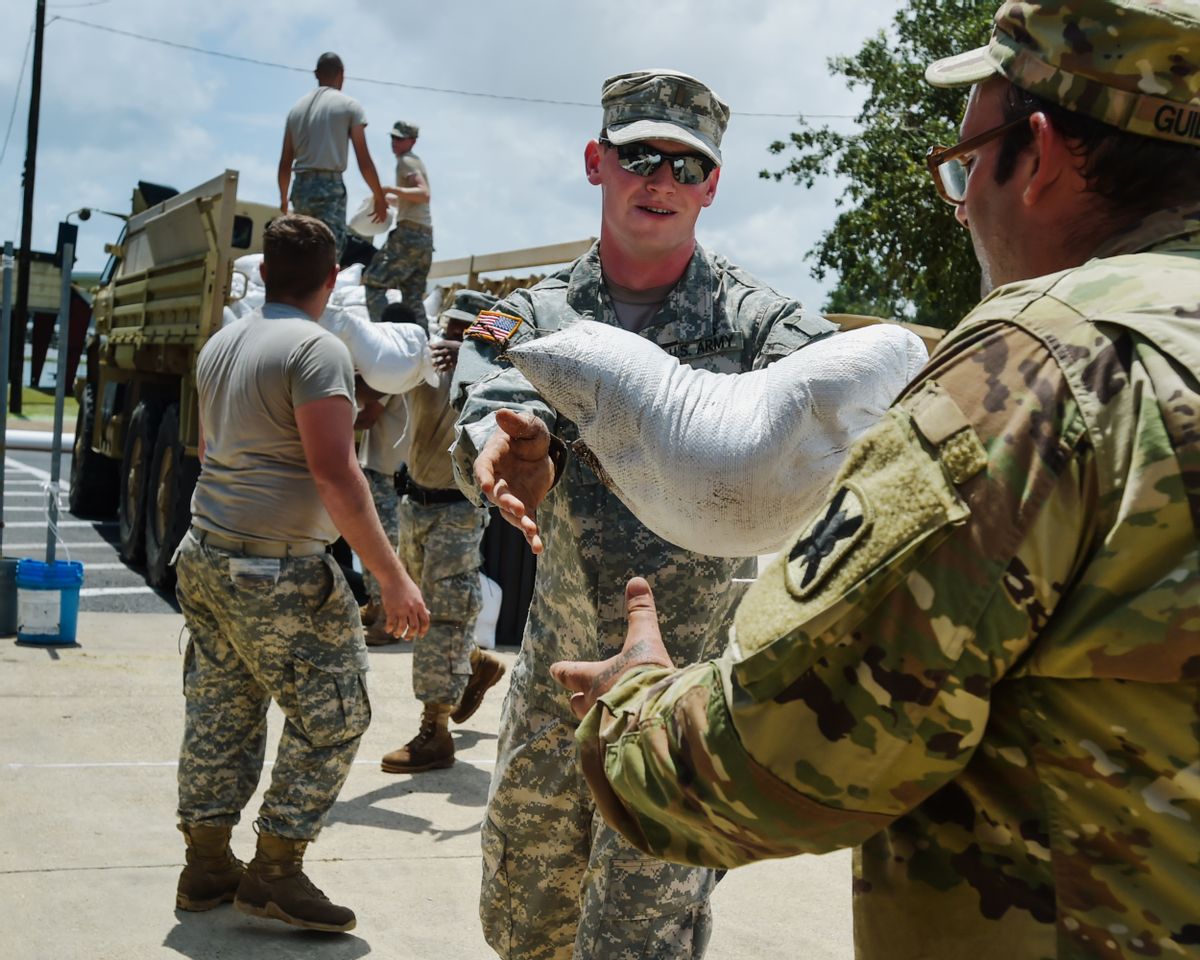 Second Lt. Dakota Jude and Army National Guard members help place sandbags to protect the city hall in Lake Arthur, La., Wednesday, Aug. 17, 2016. (Scott Clause/The Daily Advertiser via AP) (AP)