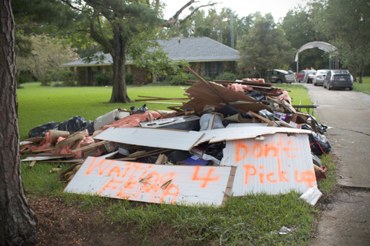 Debris piled up from flooded home on Hodgeson Road in Prairieville, Louisiana  on Sunday (Lisa O'Neill)