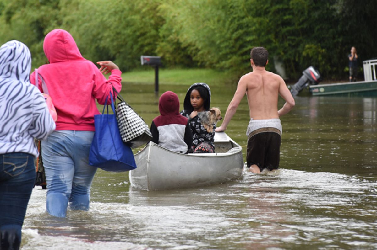 A young girl silently looks back at her family after being rescued from floodwaters that overtook Comite Drive and the surrounding neighborhoods in Central on Saturday.   (The Advocate/Caroline Ourso)