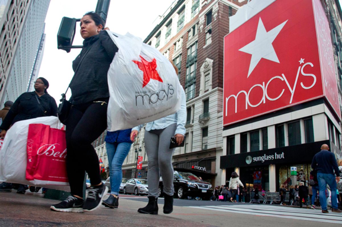 FILE - In this Nov. 27, 2015, file photo, shoppers carry bags as they cross a pedestrian walkway near Macy's in Herald Square in New York. Macy’s said Thursday, June 16, 2016, it has reached a tentative deal with the union representing workers at its flagship store in New York City, avoiding a strike. (AP Photo/Bebeto Matthews, File) (AP/Bebeto Matthews)