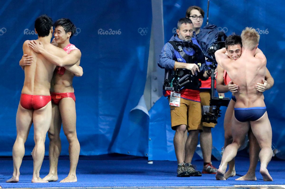 China's Cao Yuan and Qin Kai; Britain's Jack Laugher and Chris Mears hug after the men's synchronized 3-meter springboard diving final at the 2016 Summer Olympics, Aug. 10, 2016.   (AP/Wong Maye-E)