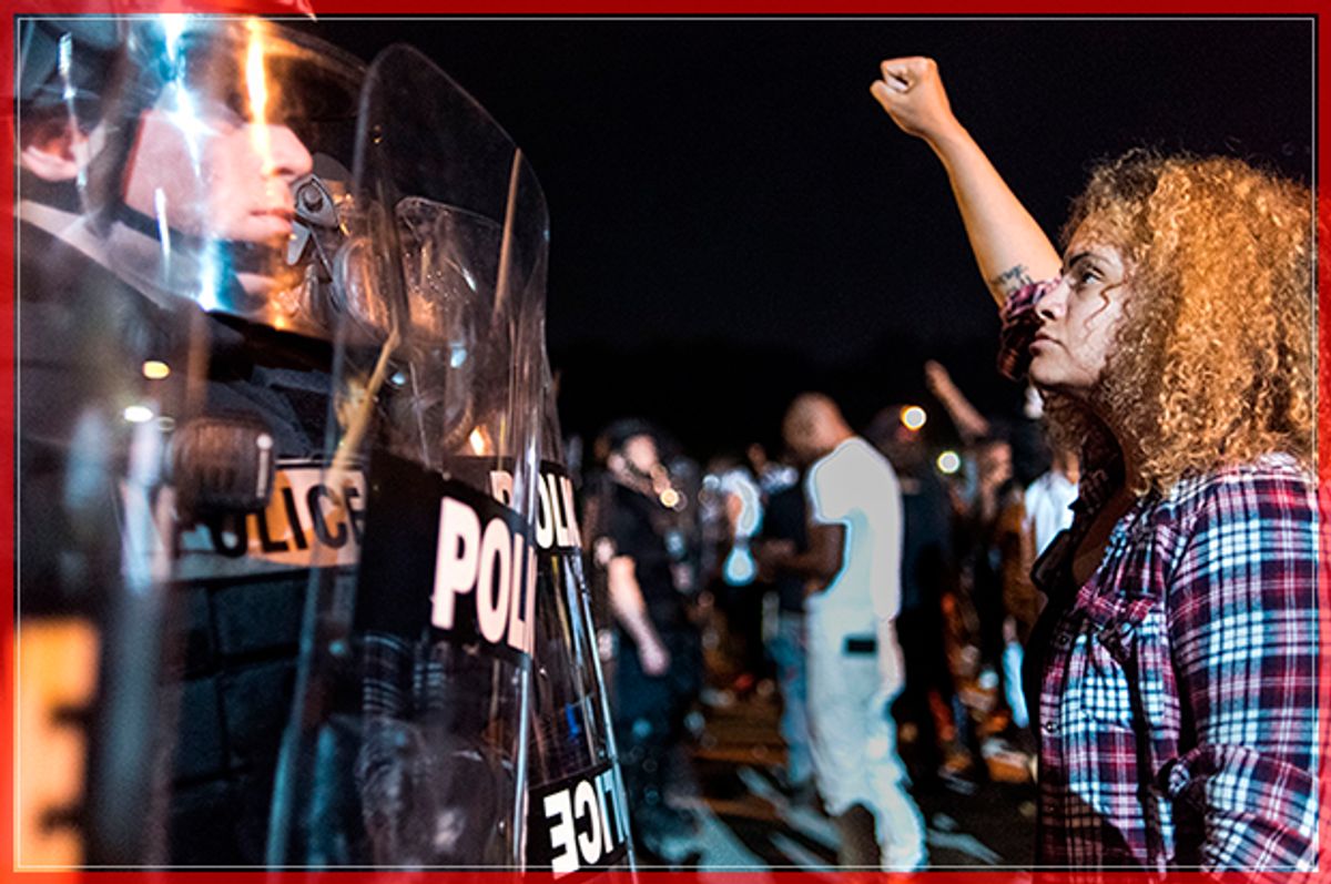 CHARLOTTE, NC - SEPTEMBER 21: Police officers face off with protestors  on the I-85 (Interstate 85) during protests following the death of a man shot by a police officer on September 21, 2016 in Charlotte, NC. The protests began the previous night following the fatal shooting of 43-year-old Keith Lamont Scott at an apartment complex near UNC Charlotte. (Photo by Sean Rayford/Getty Images) (Getty Images)