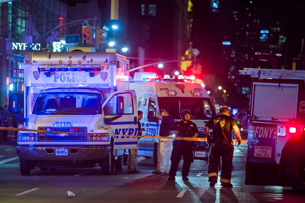 Police and firefighters work near to the scene in Manhattan, New York, Saturday, Sept. 17, 2016. Police and firefighters are at the scene of an apparent explosion in New York City, and authorities say 25 people suffered minor injuries. Police spokesman J. Peter Donald said on Twitter that the explosion happened at about 8:30 p.m. Saturday on West 23rd Street in the Chelsea section of Manhattan. (AP Photo/Andres Kudacki) (AP)
