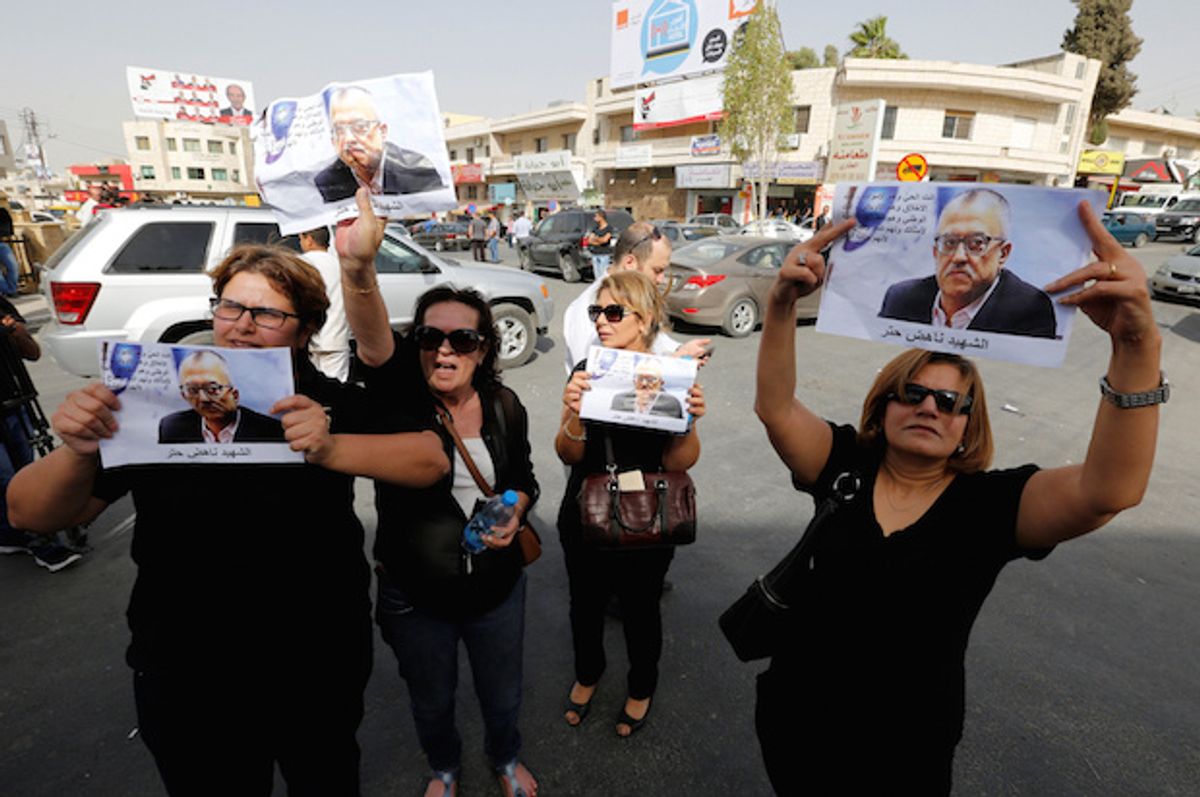 Relatives and friends of the Jordanian writer and activist Nahed Hattar hold pictures of him during a protest in the town of Al-Fuheis, near Amman, Jordan, on September 25, 2016  (Reuters/Muhammad Hamed)