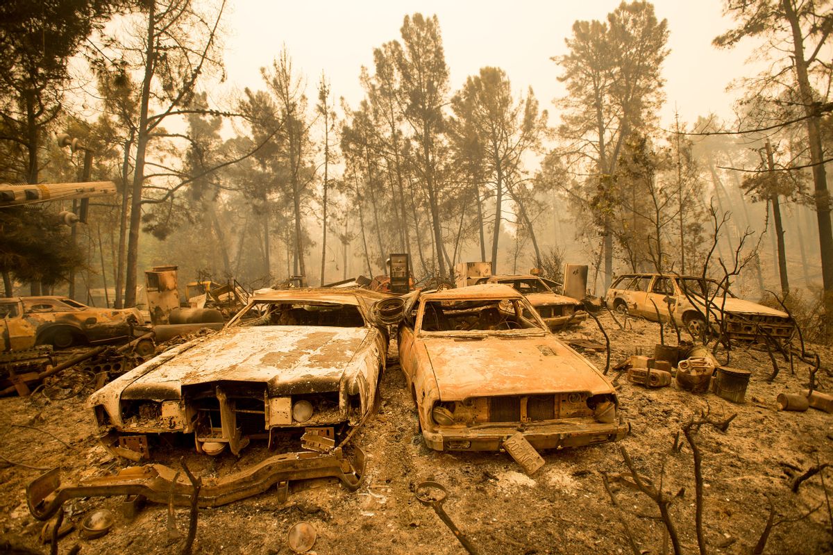 Vintage cars line a property after the Loma fire burned through Loma Chiquita Road near Morgan Hill, Calif., on Wednesday, Sept. 28, 2016.  A heat wave stifling drought-stricken California has worsened a wildfire that burned some buildings and forced people from their homes.   (AP Photo/Noah Berger) (AP)