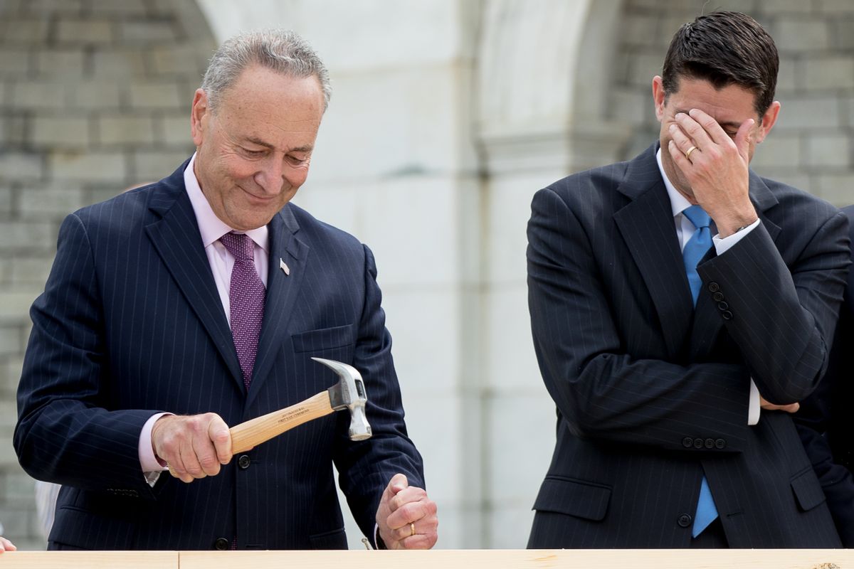 House Speaker Paul Ryan of Wis., right, hides his face and laughs at Sen. Charles Schumer, D-N.Y., bends his nail during a ceremony to drive in the first nails to signifying the start of construction on the 2017 presidential inaugural platform, Wednesday, Sept. 21, 2016, on Capitol Hill in Washington. (AP Photo/Andrew Harnik) (AP)