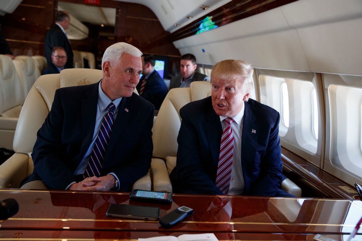 Republican presidential candidate Donald Trump talks with press, Monday, Sept. 5, 2016, aboard his campaign plane, while flying over Ohio, as Vice presidential candidate Gov. Mike Pence, R-Ind., left, looks on. (AP Photo/Evan Vucci) (AP)