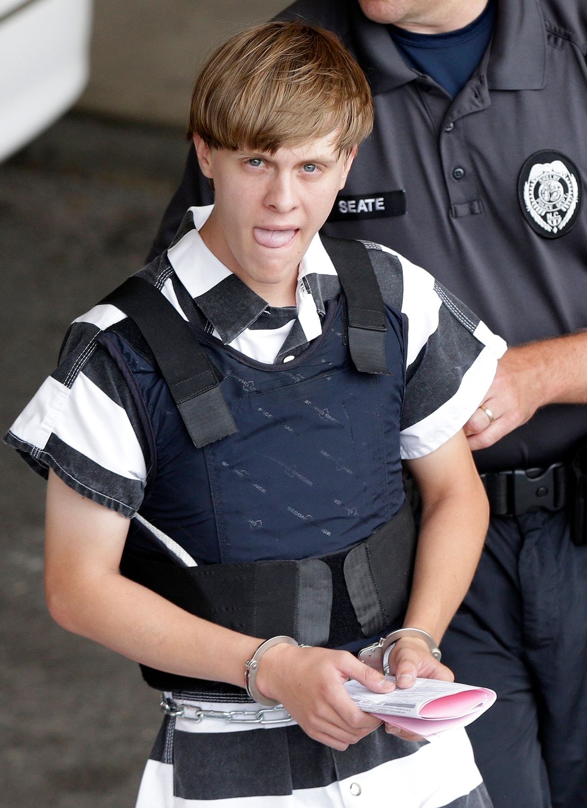 FILE - In this Thursday, June 18, 2015, file photo, Charleston, S.C., shooting suspect Dylann Roof is escorted from the Cleveland County Courthouse in Shelby, N.C. T (AP)