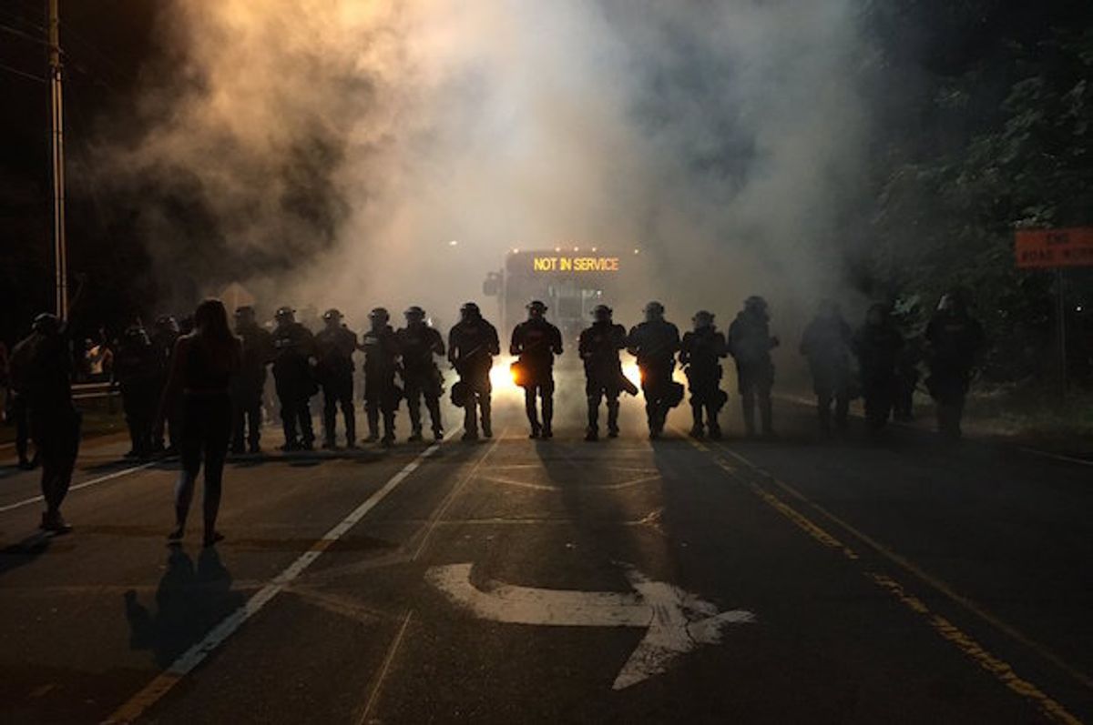 Police in riot gear use teargas to disperse protesters after police killed a disabled black man in Charlotte, North Carolina on Tuesday, September 20, 2016  (Adam Rhew/Charlotte magazine)