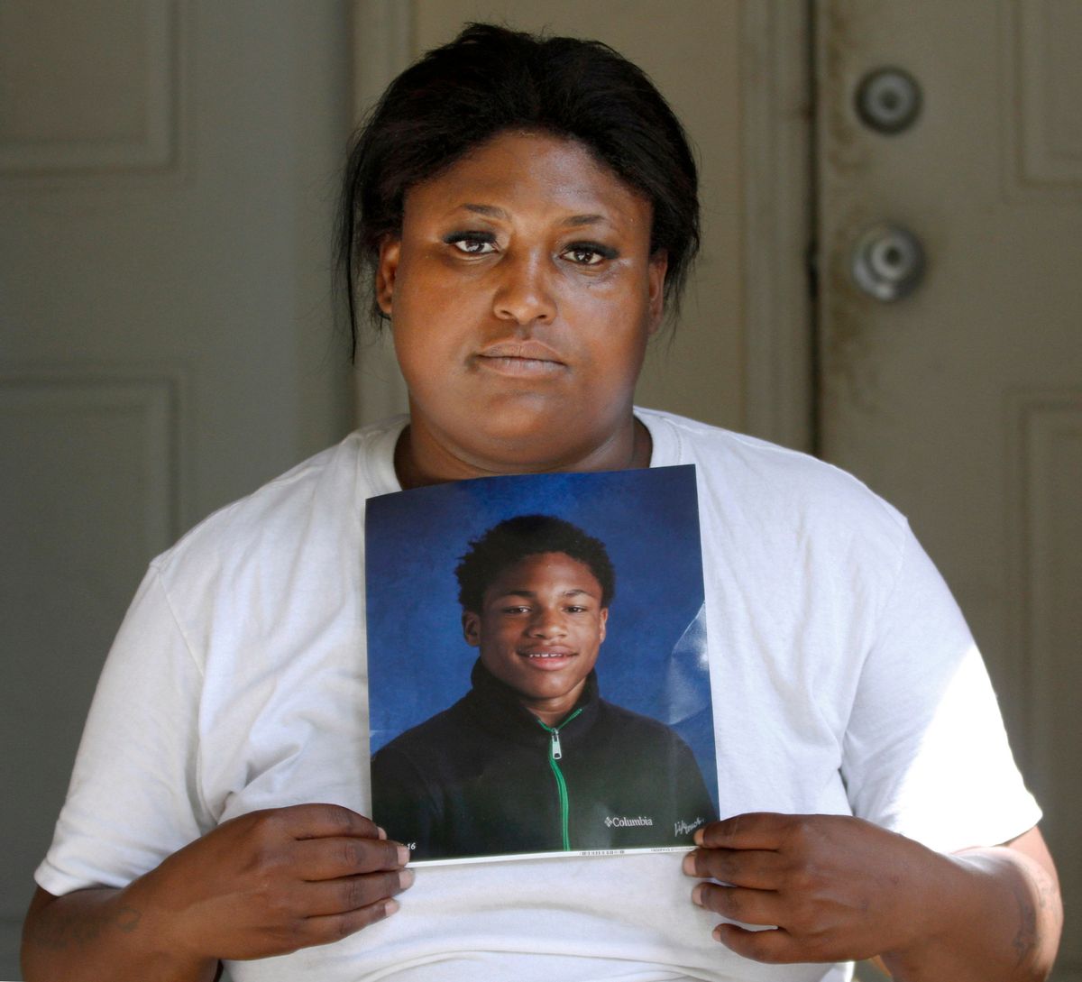 In this Sept. 7, 2016 photo, Monique Causey holds a portrait of her 14-year-old Malik, who was shot on Aug. 21, 2016, at her home in Chicago. August was the deadliest month for Chicago homicides in two decades, and an analysis of the toll shows more clearly than ever that the blame lies with surging violence in a handful of the city’s most impoverished neighborhoods riven by loosely organized street gangs. (AP Photo/Tae-Gyun Kim) (AP)