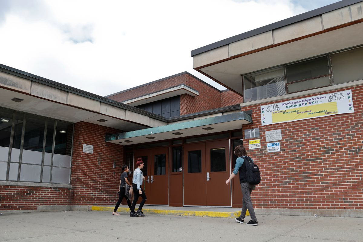 In this Tuesday, June 7, 2016 photo, students walk into the Waukegan High School's Brookside campus in Waukegan, Ill. The district struggled to meet the needs of its students even before the foreclosure crisis left blocks dotted with empty homes and businesses. (AP Photo/Kamil Krzaczynski) (AP)