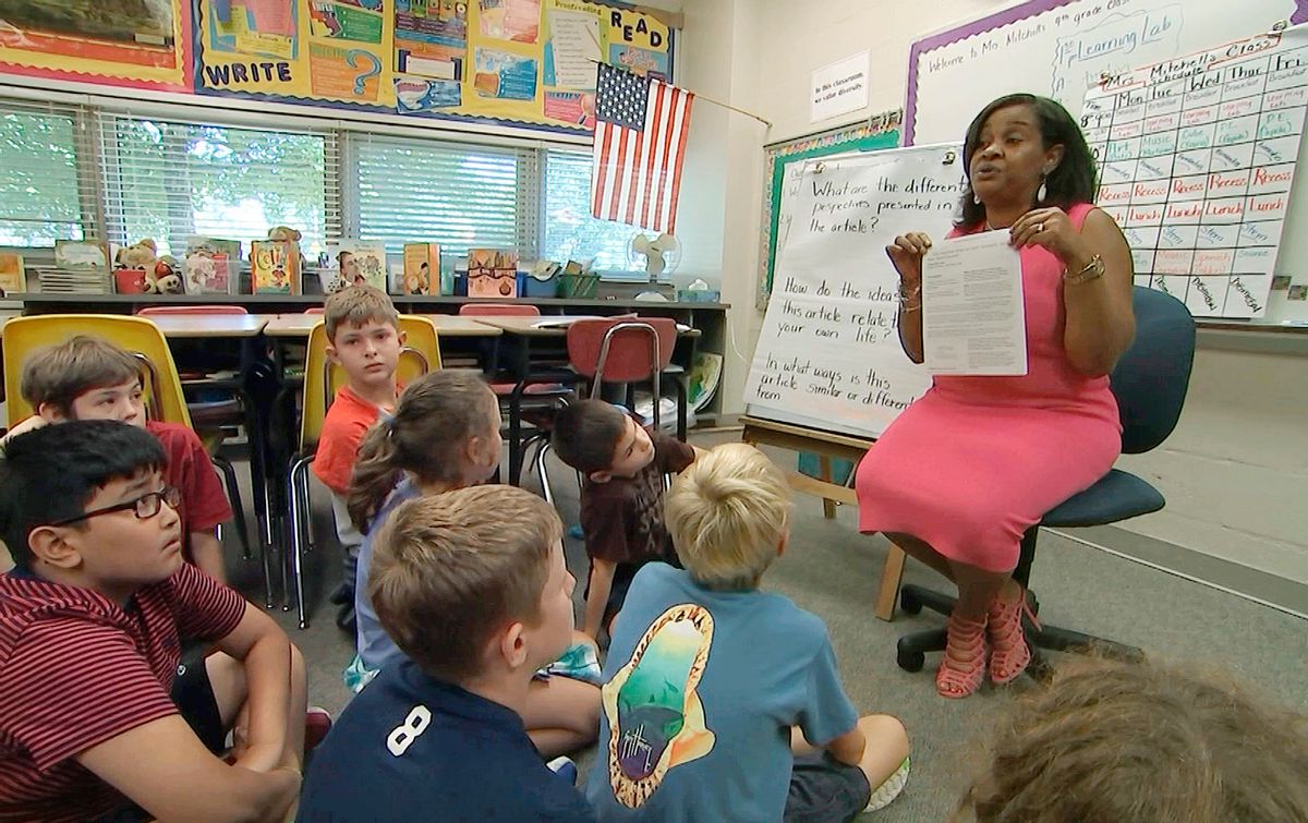 In this Tuesday, Sept. 13, 2016 still image from video, Kimberly Coleman-Mitchell, right, teaches her fourth grade class at Oakridge Elementary School in Arlington, Va. Elementary schools in Arlington, South Burlington, Vt., and Holyoke, Mass., are among those that went homework-free at the start of the school year. (AP Photo/Bill Gorman) (AP)