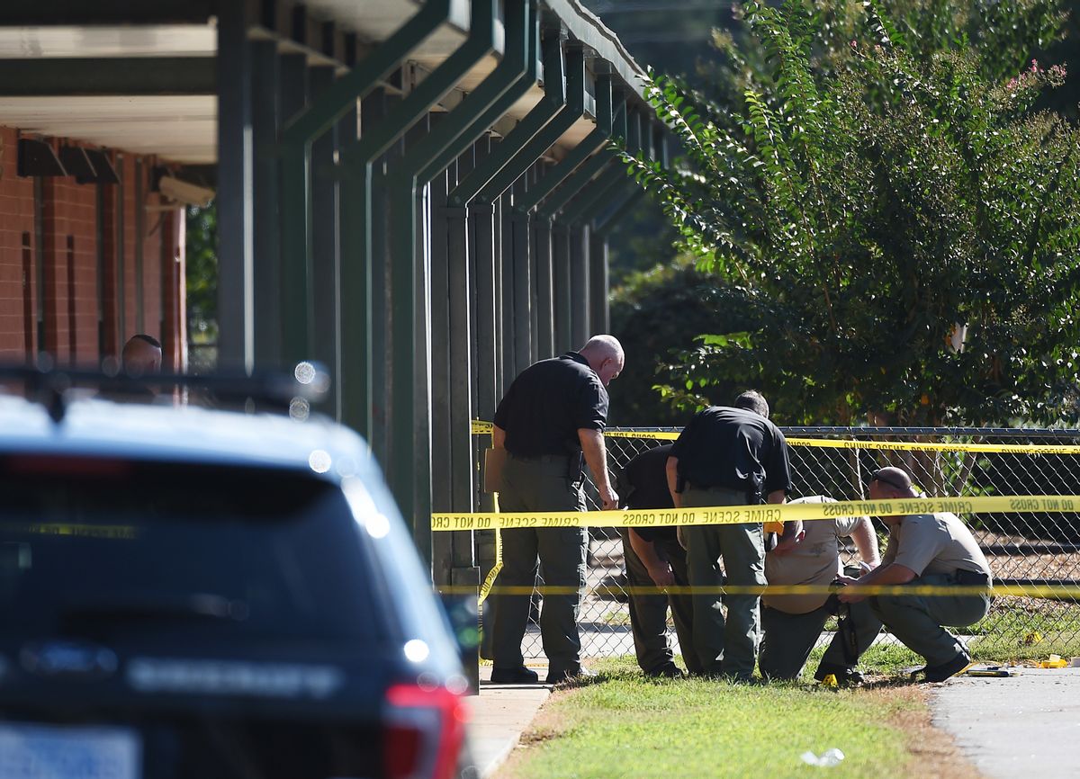Members of law enforcement investigate an area at Townville Elementary School on Wednesday, Sept. 28, 2016, in Townville, S.C.   A teenager opened fire at the South Carolina elementary school Wednesday, wounding two students and a teacher before the suspect was taken into custody, authorities said.  (AP Photo/Rainier Ehrhardt) (AP)