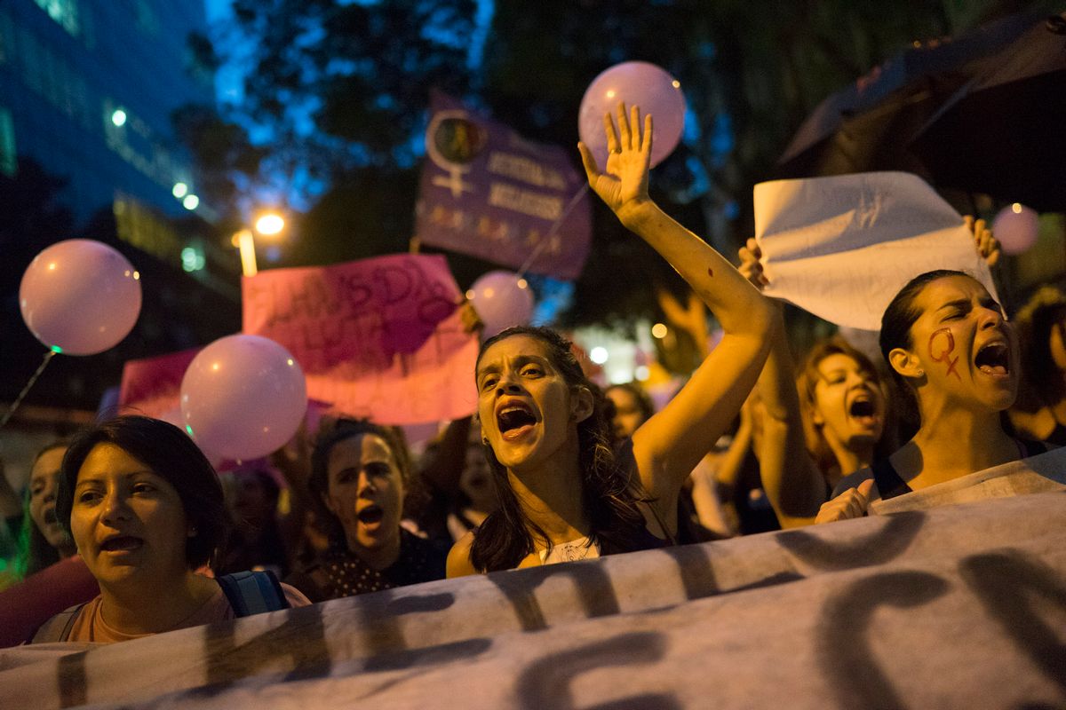 Women participate in a demonstration against gender violence in Rio de Janeiro, Brazil, Tuesday, Oct. 25, 2016. Women in Brazil organized protests condemning violence against women following the brutal gang rape of a woman on the outskirts of Rio de Janeiro by suspected drug dealers. (AP Photo/Leo Correa) (AP)