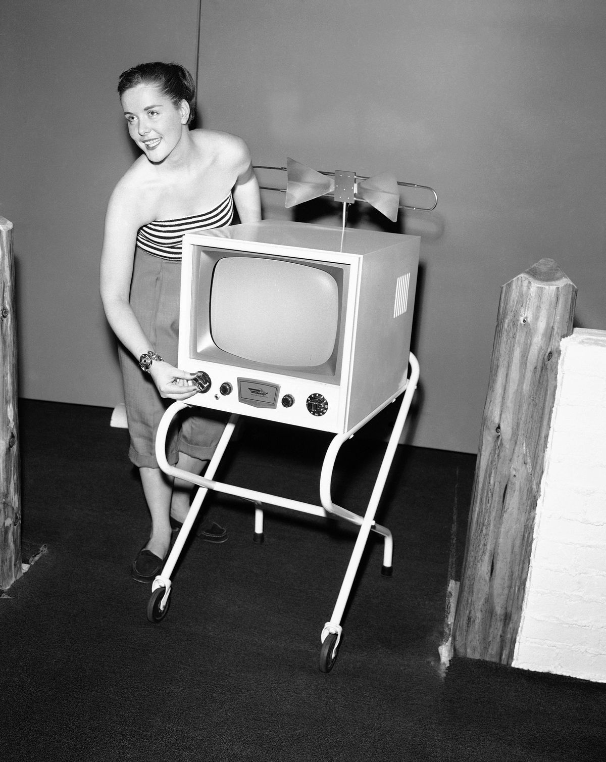 FILE - In this June 25, 1953, file photo, a demonstrator helps direct the eye to  a new television set for outdoor use, one of the new things at the Summer Home Furnishings Market in the American Furniture Mart in Chicago. TV was key to the world baby boomers were born into: a newly modernized world whose every problem (with the possible exception of the Cold War) seemed to promise an available solution. Polio would be cured! Man would go into space! Even African-Americans, oppressed for so long, had new reason for hope. TV chronicled this bracing wave of wonder and potential, and built upon it as an essential part of what distinguished boomers: They were pampered and privileged and ushered toward a sure-to-be-glorious future. (AP Photo/Edward Kitch, File) (AP)