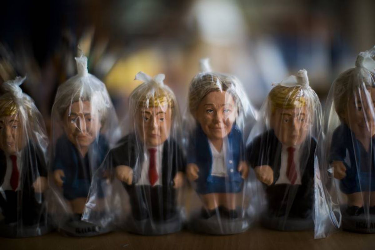 In this Monday, Oct. 3, 2016 photo, miniatures of U.S. presidential candidates Hillary Clinton and Donald Trump are wrapped in plastic bags in a "caganer" factory at Torroella de Montgri, northeast Catalonia, Spain.  A curious Christmas tradition in the Spanish autonomous region of Catalonia depicts both candidates in a rather scatological situation. The miniatures called “Caganer”, depict a person defecating, and traditionally symbolizes fertilization and a source of luck and prosperity in the new year. (AP Photo/Emilio Morenatti) (AP)
