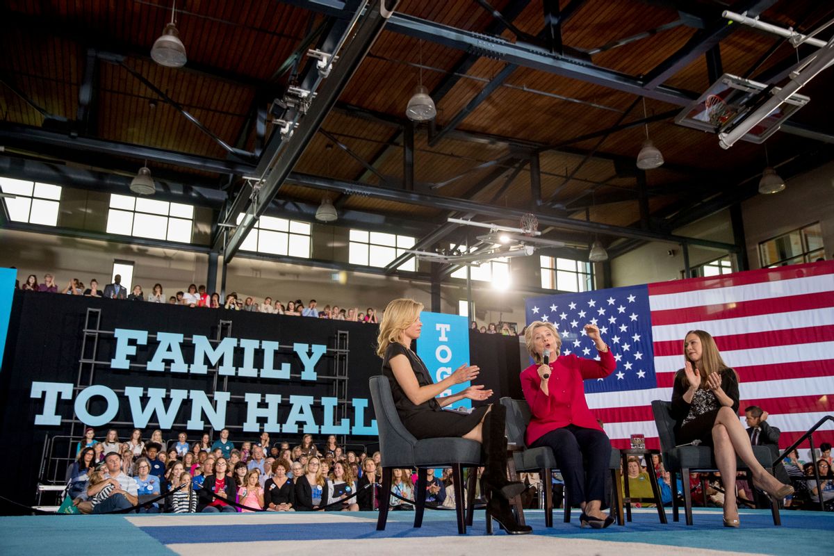 In this Oct. 4, 2016, photo, Democratic presidential candidate Hillary Clinton, center, accompanied by her daughter Chelsea Clinton, right, and actress Elizabeth Banks, speaks at a town hall at the Haverford Community Recreation and Environmental Center in Haverford, Pa. Even if your daughters don't pay much attention to politics, they'd be hard-pressed to have missed Donald Trump's attack of a former Miss Universe’s weight or comments about a 400-pound hacker. It resonated with a 15-year-old who said this week the words damage girls' body image and asked Clinton how to help. (AP Photo/Andrew Harnik) (AP)