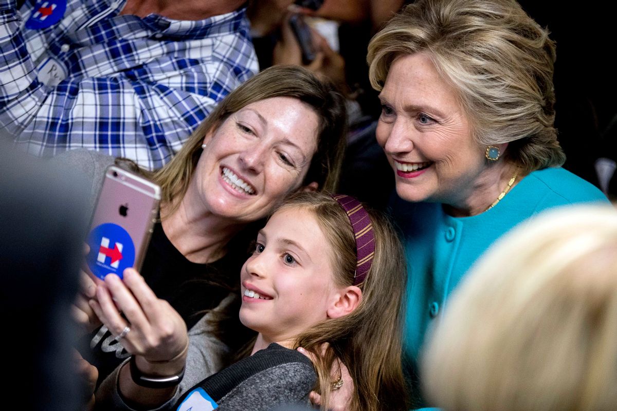 Democratic presidential candidate Hillary Clinton takes a photograph with supporters at a campaign office in Seattle, Friday, Oct. 14, 2016. (AP)