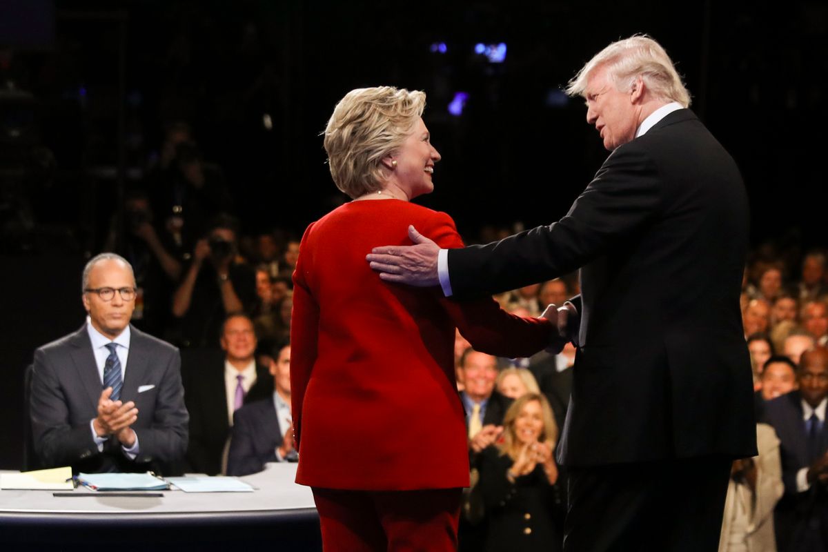FILE - In this Sept. 26, 2016 file photo, Democratic presidential nominee Hillary Clinton and Republican presidential nominee Donald Trump shake hands during the presidential debate at Hofstra University in Hempstead, N.Y. For presidential candidates, the town hall debate is a test of stagecraft as much as substance. When Hillary Clinton and Donald Trump meet in the Sunday, Oct.9, 2016, contest, they’ll be fielding questions from undecided voters seated nearby. In an added dose of unpredictability, the format allows the candidates to move around the stage, putting them in unusually close proximity to each other.  (Joe Raedle/Pool via AP, File) (AP)